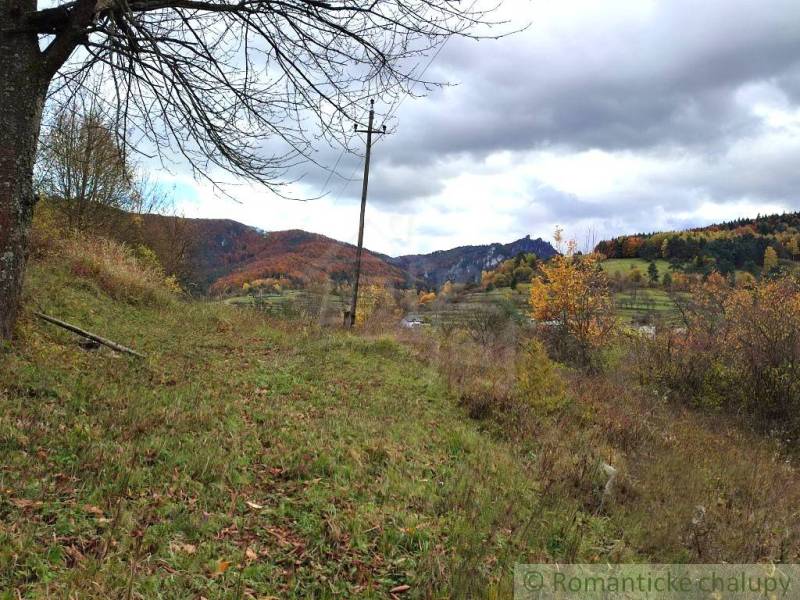 Autumn in the gardens of Hlboké nad Váhom with colorful leaves and hills in the background.