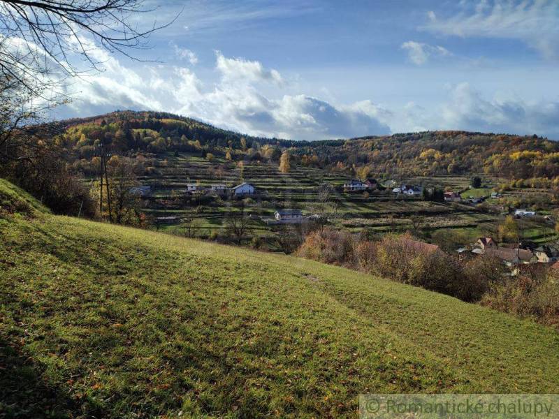 Hilly landscape with greenery and village houses in the gardens of Hlboké nad Váhom.