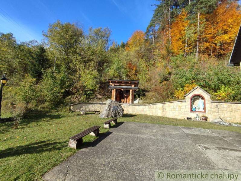 The gardens in Hlboké nad Váhom offer autumn colors of trees with a chapel and benches.