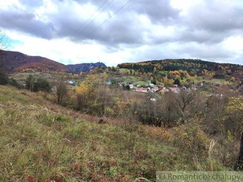Autumn landscape in Hlboké nad Váhom with a colorful forest and a village in the valley.