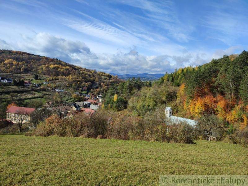 Autumn in the Gardens near Hlboké nad Váhom shows a colorful forest and picturesque houses.