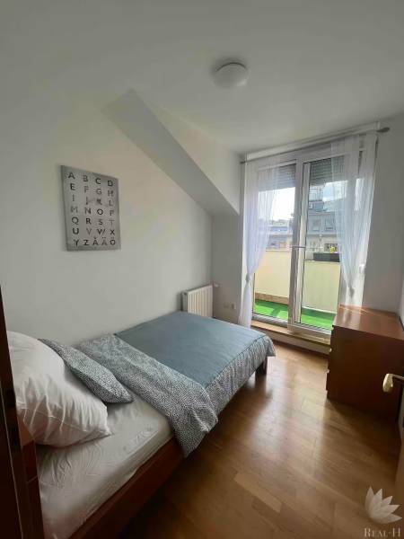 A bright room with a bed in a 3-room apartment, wall decoration with the alphabet.