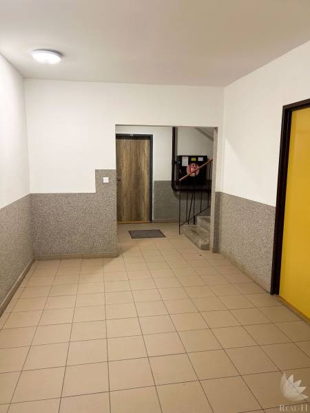 Entrance hall with tiles and stairs in a residential building.
