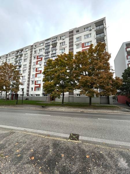 Apartment building with colorful elements and trees on Hraničná Street, Bratislava - Ružinov.