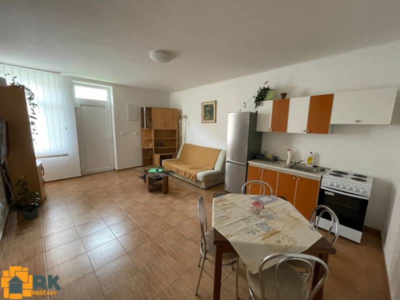 Interior of a family house with a kitchenette and a wooden decor floor.