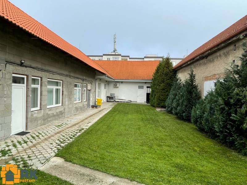 A family house on M. A. Beňovského Street in Vrbové with a lawn and a paved terrace.