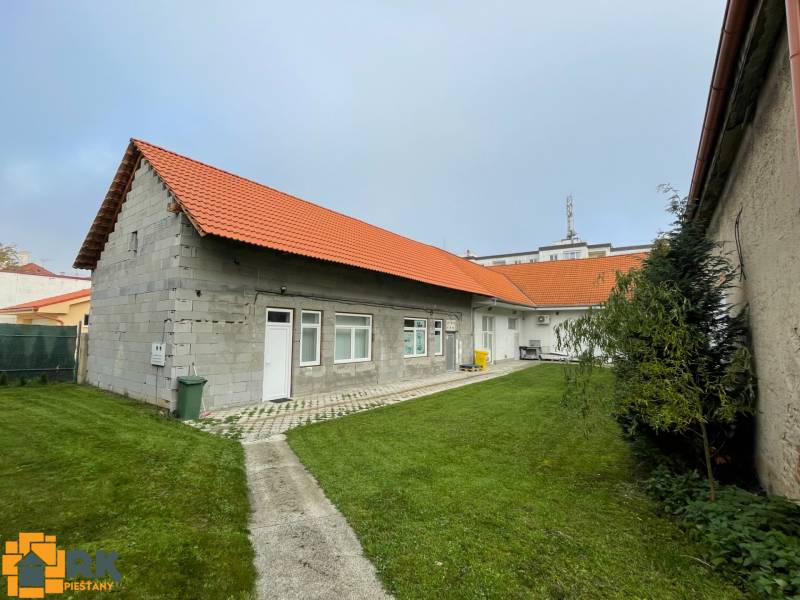 A family house on M. A. Beňovského Street in Vrbové, with a red roof and a lawn.