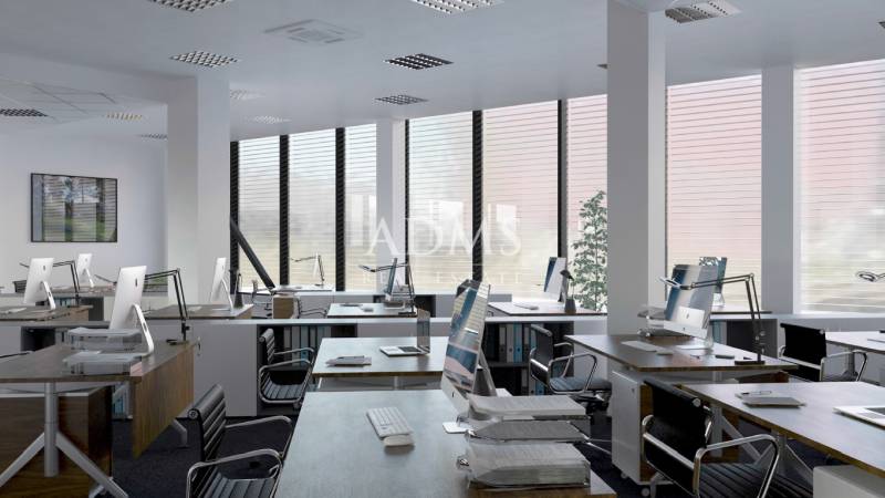 Offices with computers, chairs, and large windows, floor with wooden decor.