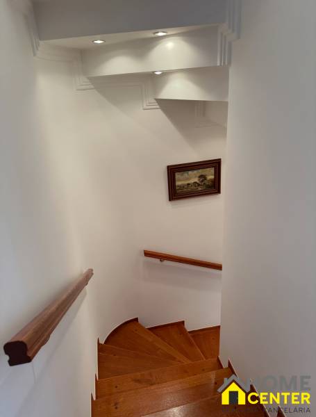 Spiral staircase with wood-patterned flooring in a family house.