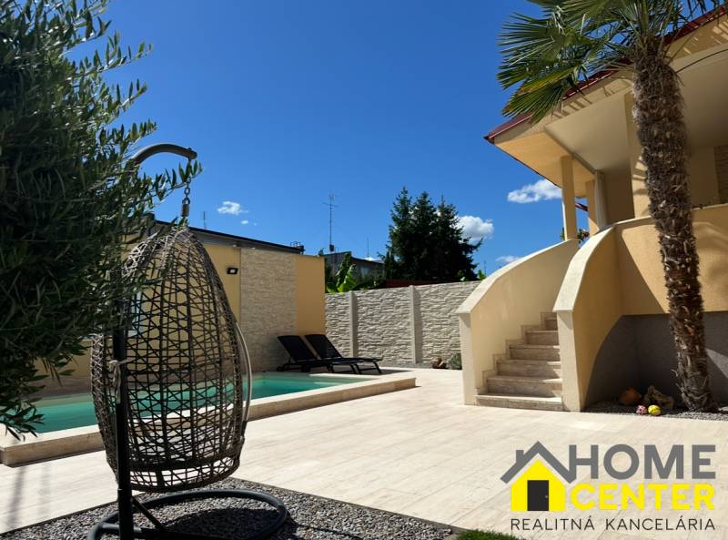 Family house in Komárno, exterior with garden, swimming pool, and relaxation corner.