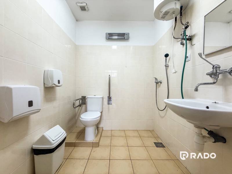 Accessible toilet with shower and sink in the offices.
