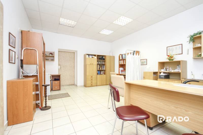 Offices with white walls, wooden furniture, and ceramic flooring.