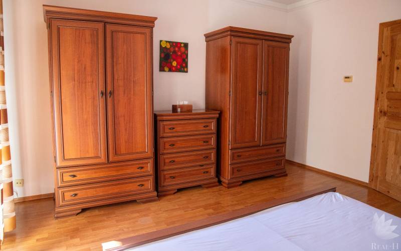 Wooden furniture with wood-decor flooring in a 2-room apartment, elegant composition.