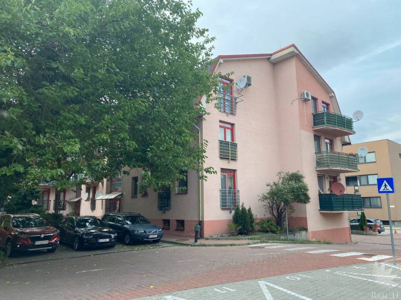 Apartment building on Mierová Street in Bratislava-Ružinov with parking spaces in the front.