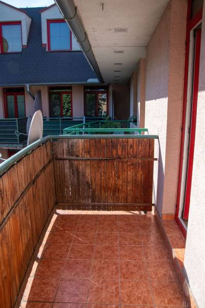 The balcony of the apartment on Mierová Street in Bratislava - Prievoz, with wooden railing and tiles.