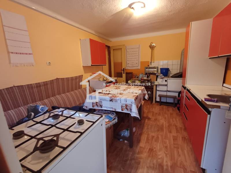 A kitchen in a family house with a gas stove and a wooden decor floor.