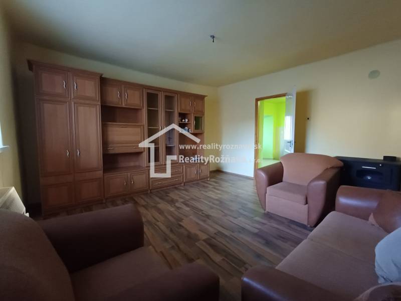Living room with wood-patterned flooring in a family house.