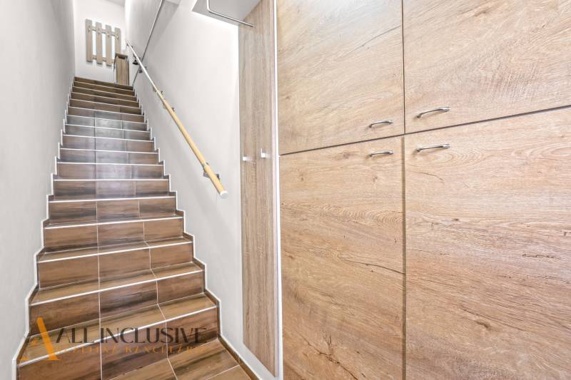 Stairs with a wooden decor floor leading to built-in wardrobes in a 3-room apartment.