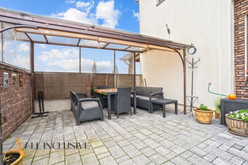 In Gabčíkovo, sitting on the terrace of a 3-room apartment with garden furniture on the tiles.