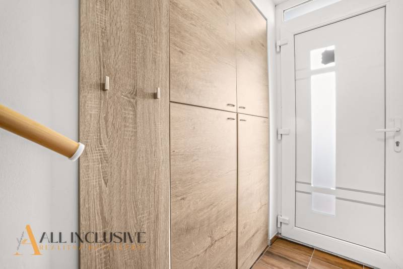 Entrance hallway with a built-in wardrobe and white doors in a 3-room apartment.