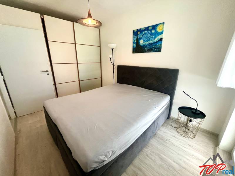 Bedroom in a 3-room apartment with a wardrobe and a nightstand.