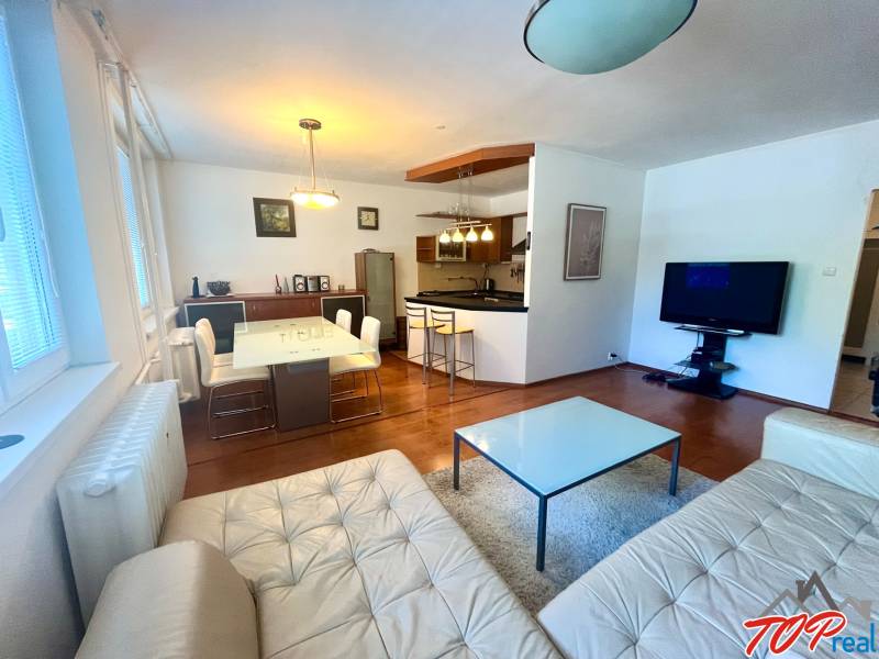 Living room with kitchen in a 3-room apartment, equipment includes a sofa, table, and television.