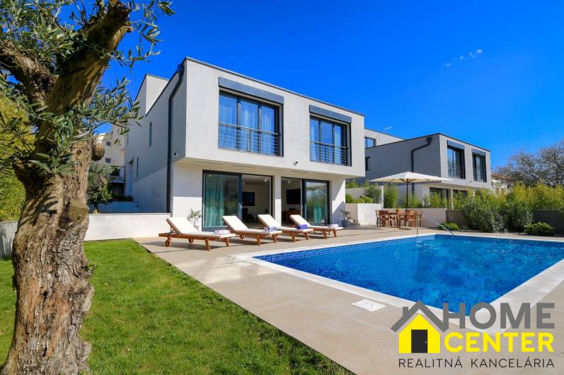 A villa in Bale with a swimming pool, sun loungers, and a garden for relaxation.