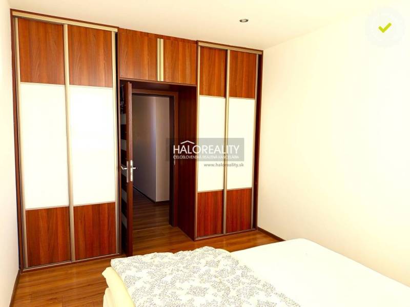 Bedroom with a built-in wardrobe and wooden decor flooring in a 3-room apartment.
