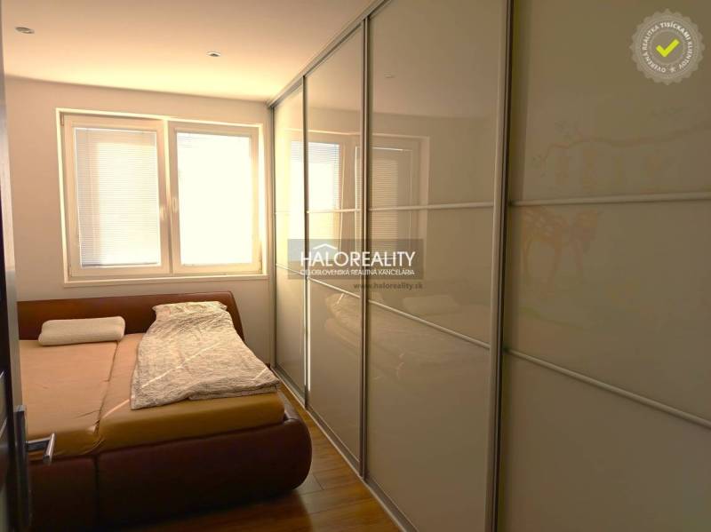 Bedroom in a 3-room apartment with a large wardrobe and a floor with a wooden decor.