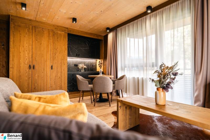 Interior of a 2-room apartment with a wooden decor floor, stylish furniture, and curtains.