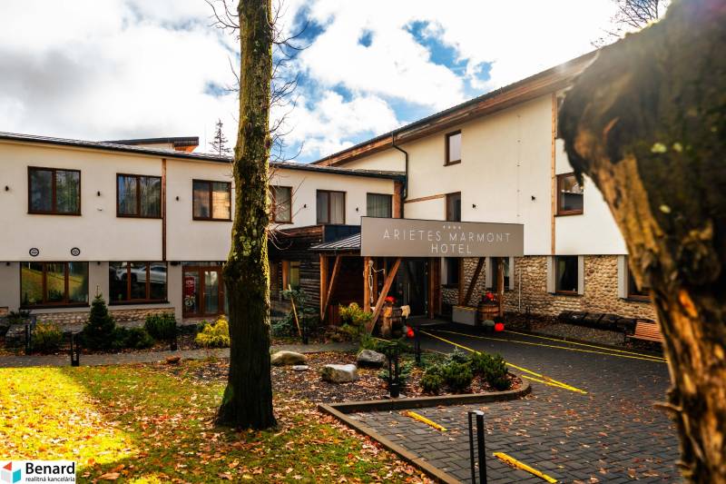 The hotel building with trees and falling leaves in Štrba on Lúčna Street.