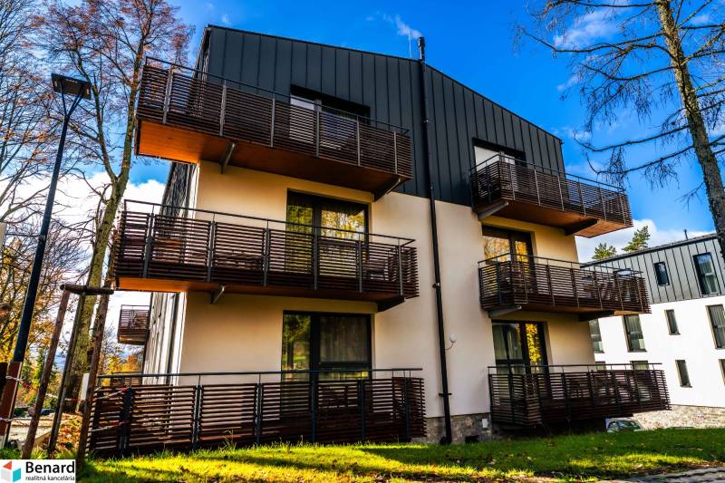 Apartment building on Lúčna Street in Štrba with modern balconies and surrounding greenery.