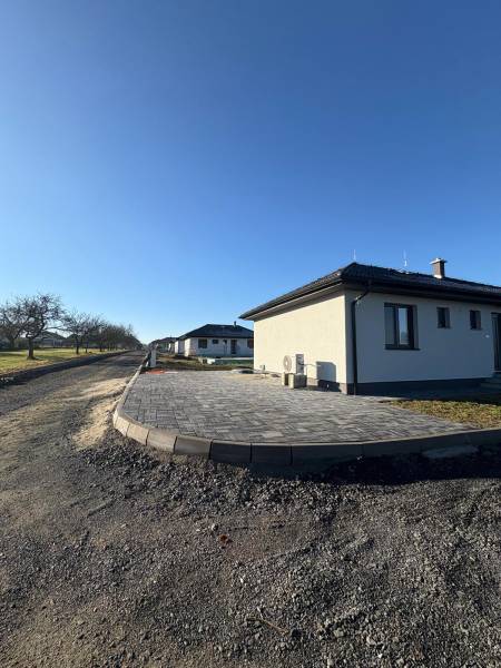 Family house on Vyšná Šebastová Street in Prešov, paved terrace, clear blue sky.