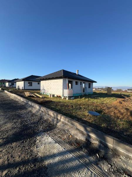 A family house under construction on Vyšná Šebastová Street in Prešov under a clear sky.