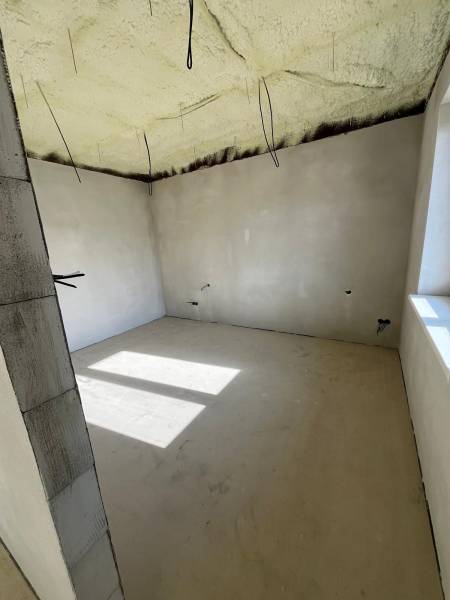 An insulated ceiling in a family house on Vyšná Šebastová Street. A bright room with a large window.