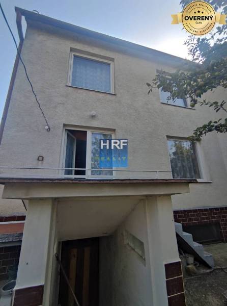 Family house in Radošovce in Vieska with an external staircase and white facade.