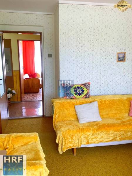 Living room in a family house with colorful blankets and upholstery on the couches.