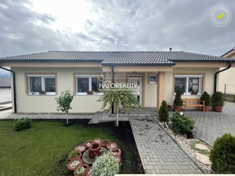 A family house in Malinová with a landscaped garden, lawn, and garden decorations.