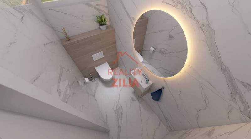 A bathroom with a round mirror, sanitary ware, and decorative tiles in a family house.