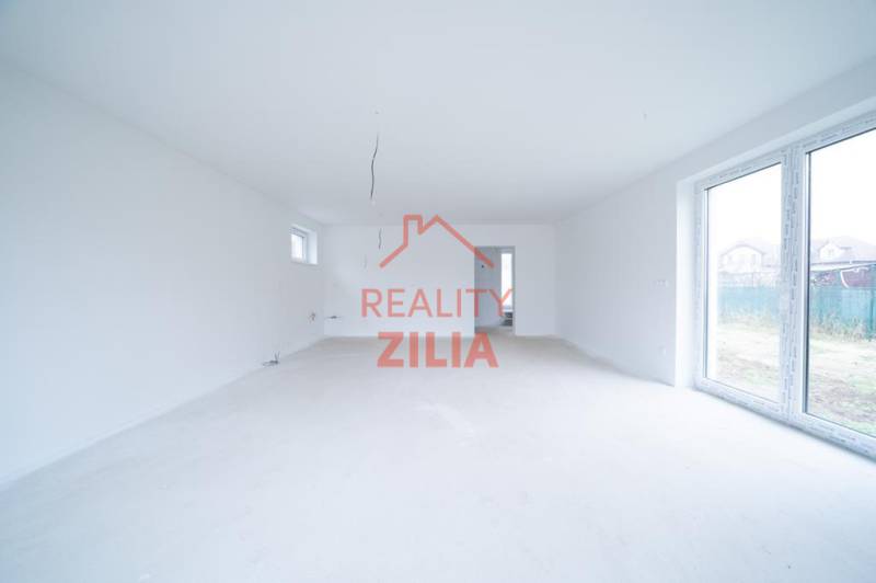 A spacious bright room in a family house with large windows.