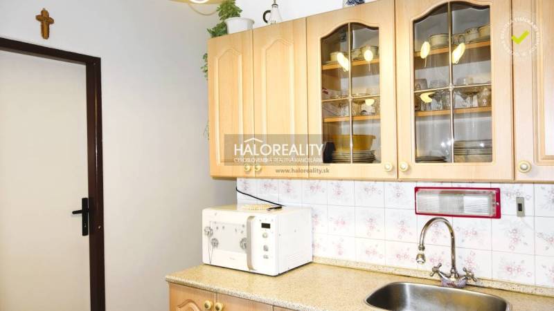 Kitchen in a 3-room apartment with cabinets, a microwave, and a sink.