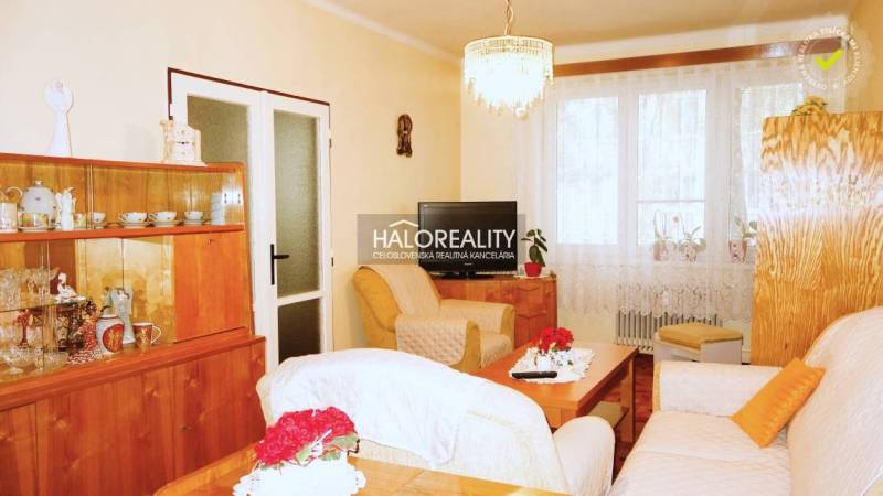 Living room with furniture and decorations in a 3-room apartment, floor with wood decor.