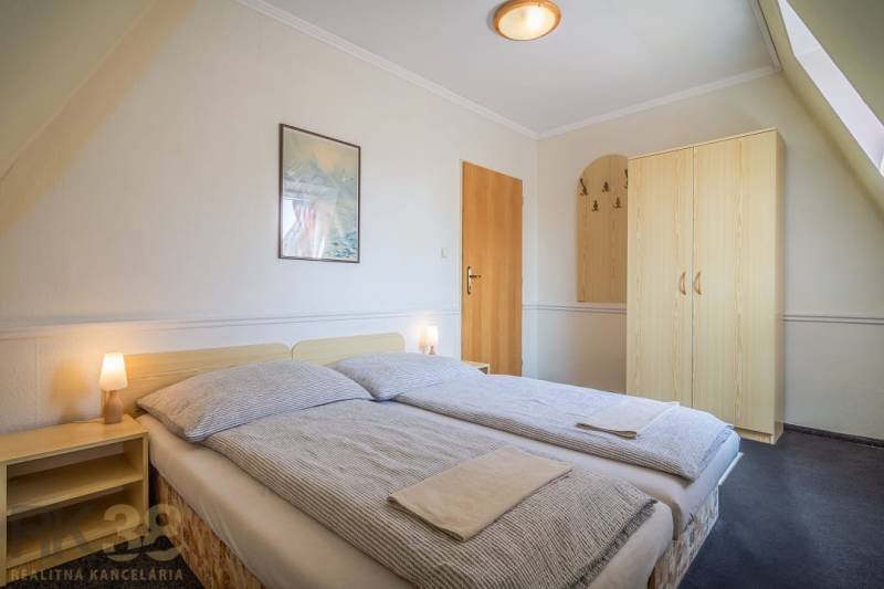 Double room with a bed, nightstands, and a wardrobe in hotels and guesthouses.