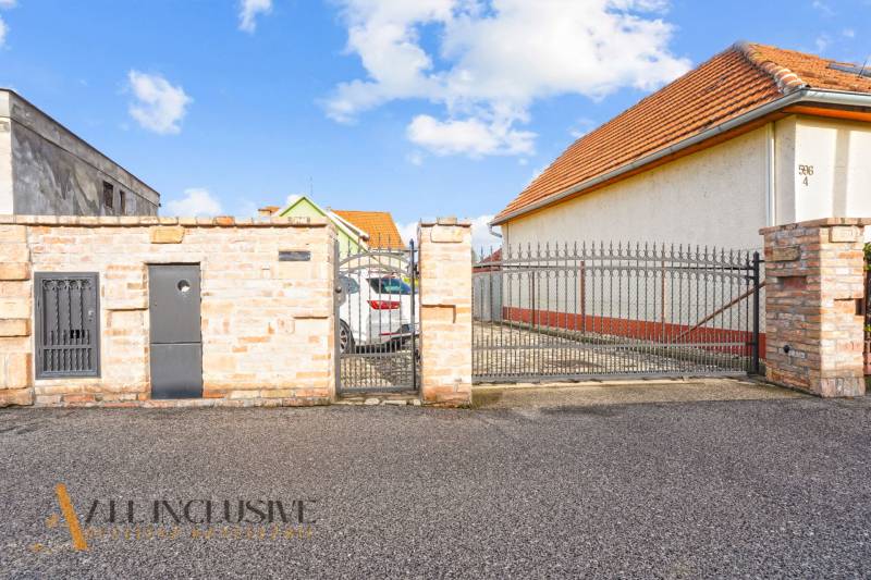 Family house on Kúpeľná Street in Dunajská Streda with a gate and a paved yard.