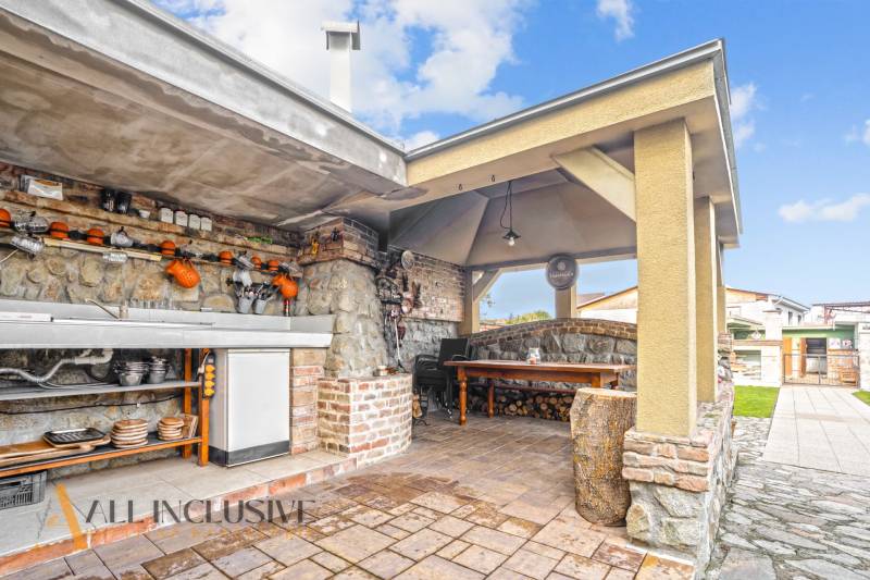 The exterior of a family house on Kúpeľná Street in Dunajská Streda, outdoor kitchen with seating area.