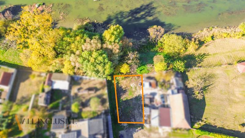 Aerial view of a residential plot in Jahodná, surrounded by greenery near the water.