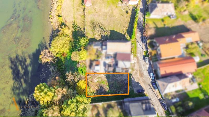 An aerial view of the land in Jahodná, surrounded by greenery and a water body.