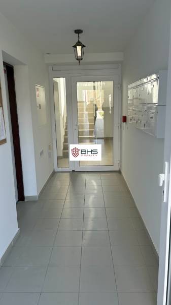 Entrance hallway with white doors and mailboxes in a 3-room apartment.
