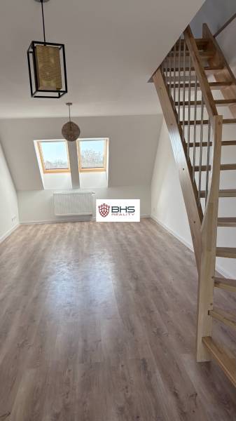 3-room apartment with wood-patterned flooring and wooden staircase.
