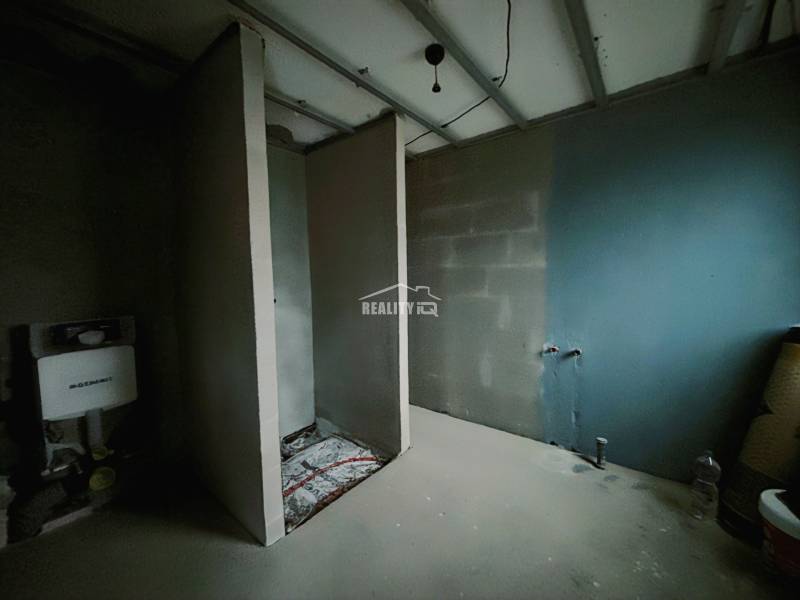 Interior of a family house with an unfinished bathroom and installations for a toilet and sink.